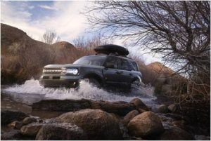 A 2021 Ford Bronco Sport driving through water.