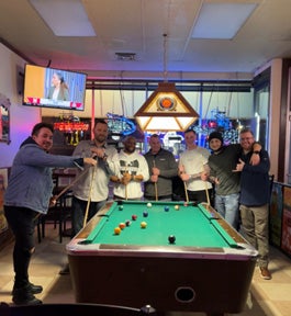 A group of men playing pool