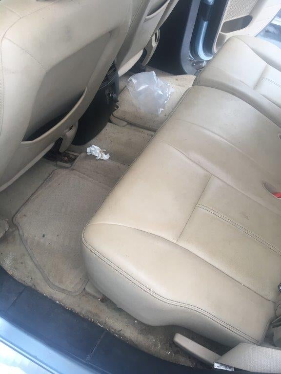 Middle seat of a car before cleaning.